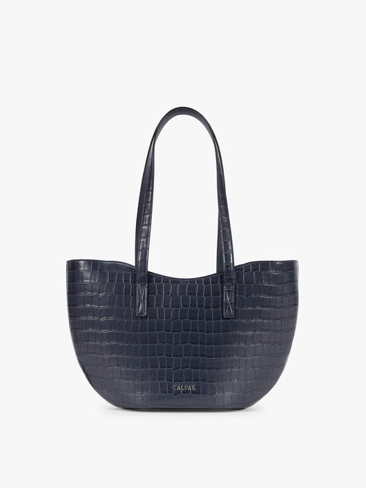 A navy blue crocodile-embossed CALPAK Haven Tulip tote bag with double shoulder straps against a plain white background; AHP2601-NAVY-FAUX-CROC