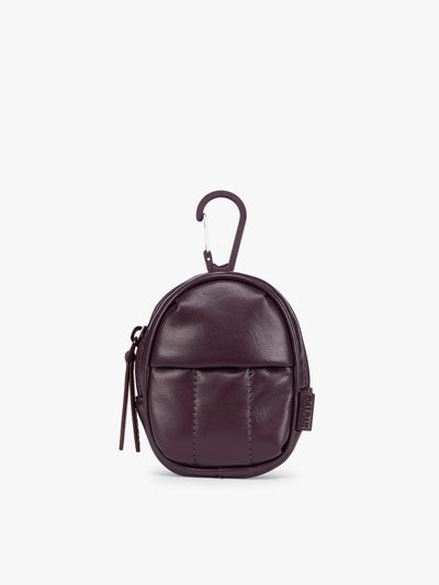 A small dark burgundy Dark Cherry CALPAK Luka Backpack Zip Bag Charm leather backpack keychain with a top carabiner and zipper pull, shown on a plain white background; AMB2201-DARK-CHERRY-PU