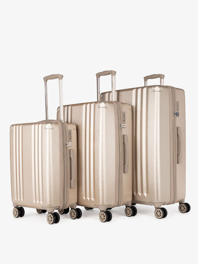 CALPAK Ambeur: 3 piece lightweight expandable gold hard shell luggage set with carry on; LAM3000-GOLD