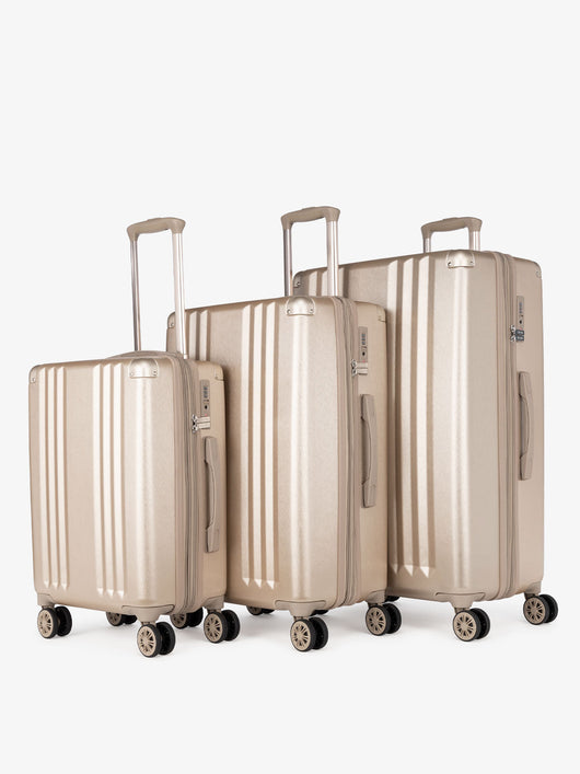 CALPAK Ambeur: 3 piece lightweight expandable gold hard shell luggage set with carry on; LAM3000-GOLD