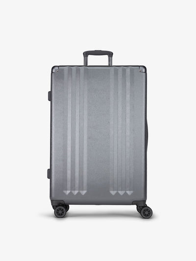 Studio product shot of front-facing CALPAK Ambeur large 30-inch hardshell luggage with 360 spinner wheels in gunmetal; LAM1028-GUNMETAL
