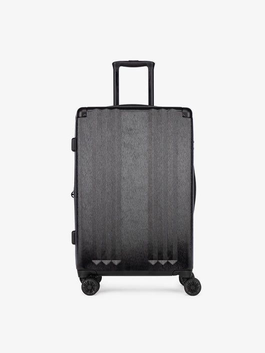 Studio product shot of front-facing CALPAK Ambeur black medium 26-inch lightweight hardshell rolling luggage; LAM1024-BLACK