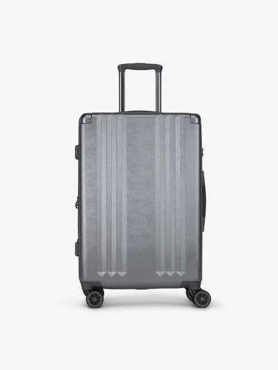 Studio product shot of front-facing CALPAK Ambeur medium 26-inch lightweight hardshell luggage with 360 spinner wheels in gunmetal; LAM1024-GUNMETAL