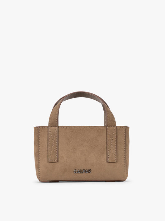 A CALPAK Haven Mini Crossbody Bag in brown Truffle Suede with top handles on a plain white background; AMC2502-TRUFFLE-FAUX-SUEDE