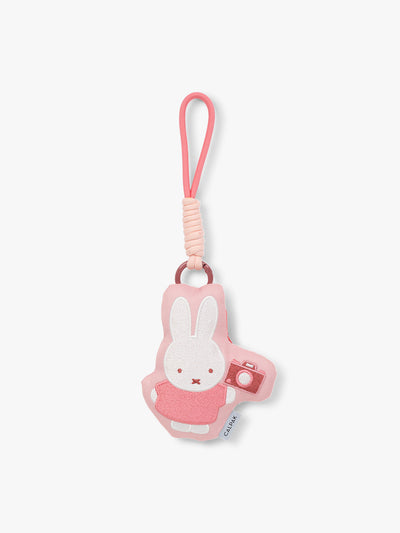 Plush Miffy x CALPAK Pluffy Bag Charm keychain with a pink border and Miffy holding a camera on a white background; APLF2501-MIFFY-MAKES-MEMORIES
