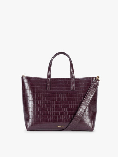 CALPAK Haven 15" Laptop Tote in deep red Dark Cherry crocodile-embossed with dual top handles and a matching shoulder strap against a plain white background; ATS2501-DARK-CHERRY-FAUX-CROC