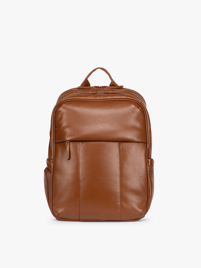CALPAK Honey Brown Luka 15 inch Laptop Backpack in vegan leather with a glossy finish, featuring a top carry handle, a main zippered compartment, and a front slip pocket, shown against a plain white background; BPL2001-HONEY-BROWN-PU