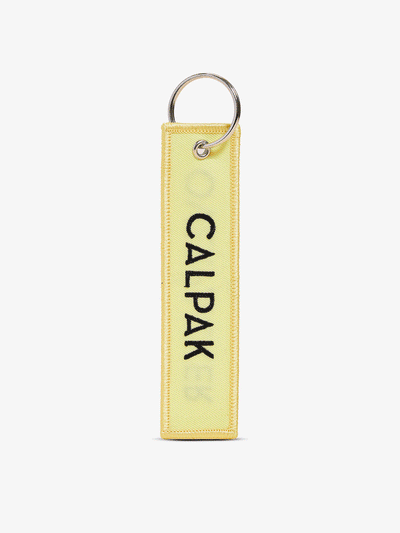 Gif of front-view and back-view of CALPAK Overpacker Luggage Tag in yellow; CPK2401-PATCH