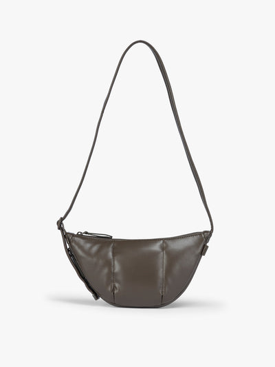 A dark brown vegan leather Luka Crescent shoulder bag with a long thin strap, shown against a plain light gray background; CBL2601-MUSHROOM-PU