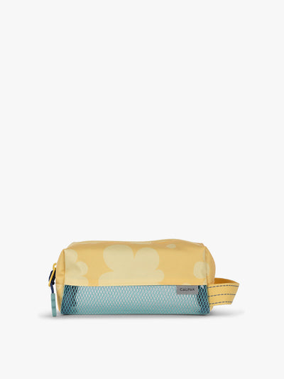 CALPAK Kids Pencil Case in yellow with tan flower print in Yellow Bloom front view with yellow zippers and blue mesh front pocket; CKPC2501-YELLOW-BLOOM