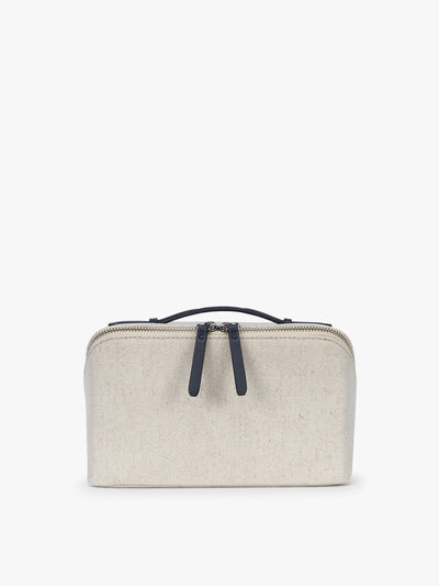 CALPAK Colette Lay-Flat Canvas Toiletry Bag in beige canvas material and blue finishing; CLTB2601-NATURAL-NAVY