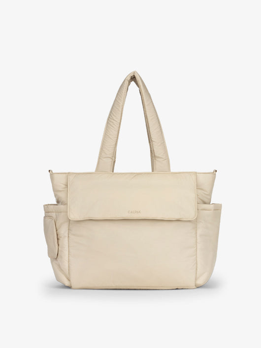 CALPAK Diaper Tote Bag with Laptop Sleeve made with durable, recycled, water-resistant material and a magnetic front pocket closure in oatmeal; TBB2401-OATMEAL