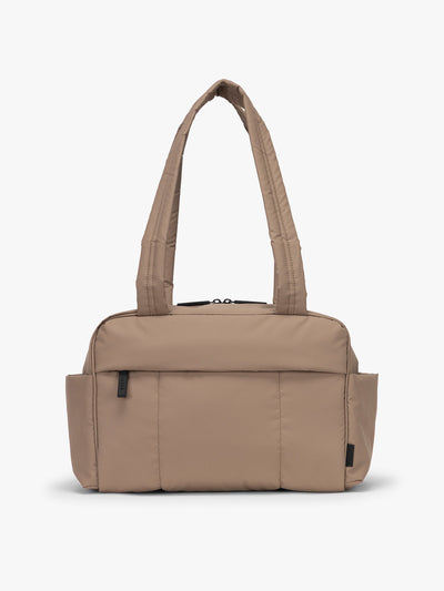 CALPAK Mini Duffel in brown Chocolate front view with puffy exterior, interior and exterior pockets, and padded shoulder straps; DLM2501-CHOCOLATE