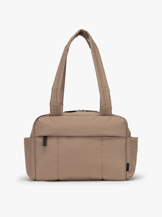 CALPAK Mini Duffel in brown Chocolate front view with puffy exterior, interior and exterior pockets, and padded shoulder straps; DLM2501-CHOCOLATE