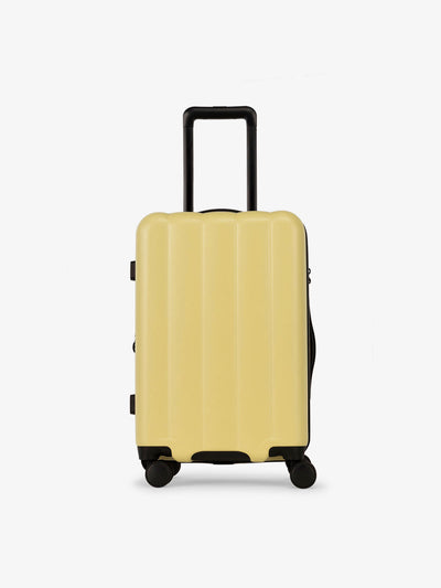 CALPAK Pacific blue carry-on luggage made from an ultra-durable polycarbonate shell and expandable by up to 2" in butter; LCO1020-BUTTER