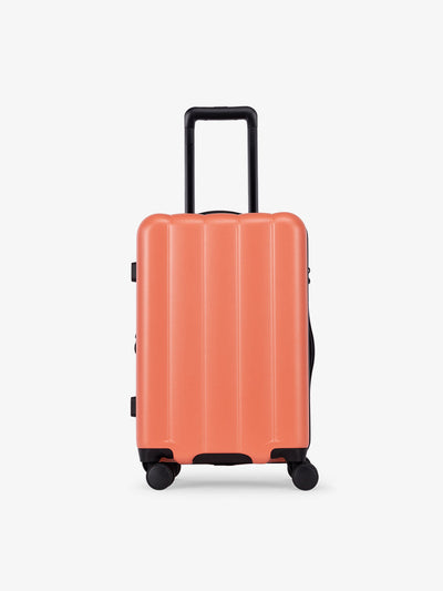 CALPAK Pacific blue carry-on luggage made from an ultra-durable polycarbonate shell and expandable by up to 2" in persimmon; LCO1020-PERSIMMON
