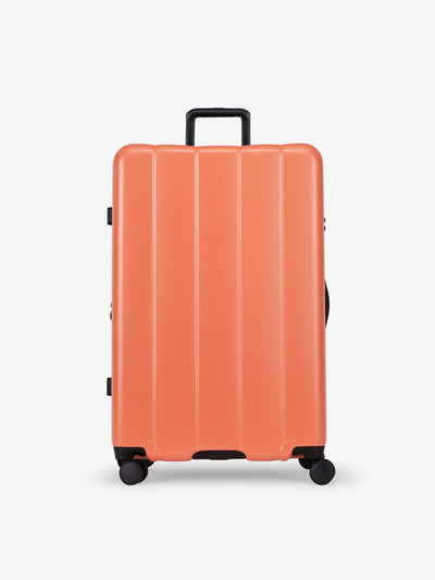 CALPAK persimmon orange large luggage made from an ultra-durable polycarbonate shell and expandable by up to 2"; LCO1028-PERSIMMON