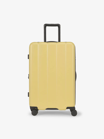 CALPAK Butter medium luggage made from an ultra-durable polycarbonate shell and expandable by up to 2"; LCO1024-BUTTER