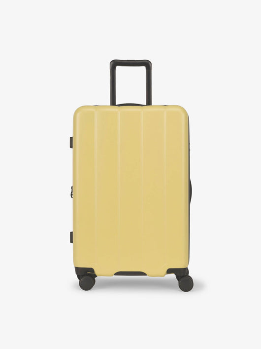 CALPAK Butter medium luggage made from an ultra-durable polycarbonate shell and expandable by up to 2"; LCO1024-BUTTER