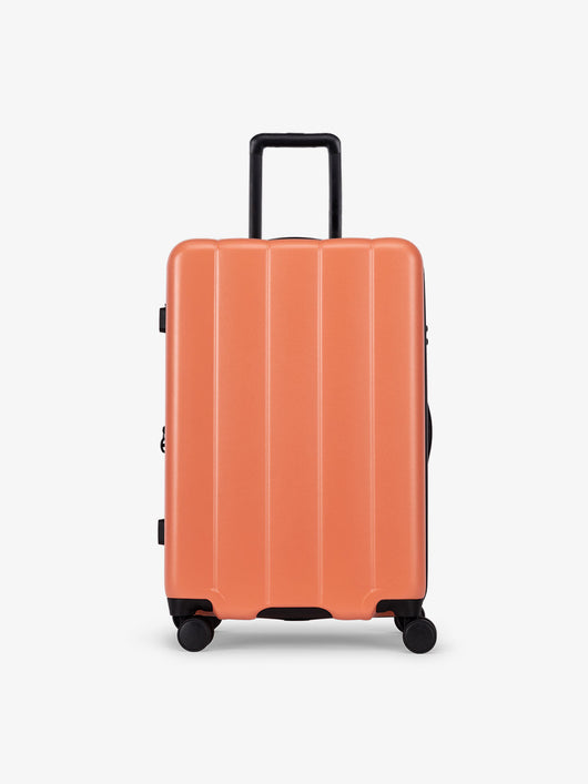 CALPAK Persimmon medium luggage made from an ultra-durable polycarbonate shell and expandable by up to 2"; LCO1024-PERSIMMON
