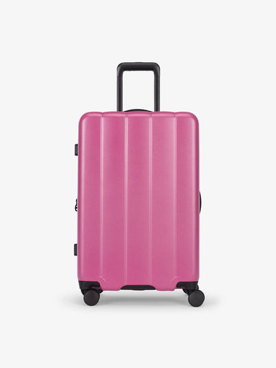 CALPAK raspberry medium luggage made from an ultra-durable polycarbonate shell and expandable by up to 2"; LCO1024-RASPBERRY