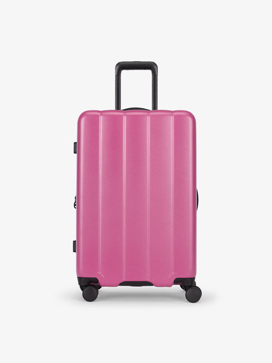 CALPAK raspberry medium luggage made from an ultra-durable polycarbonate shell and expandable by up to 2"; LCO1024-RASPBERRY