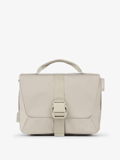 Front view of CALPAK Fit Hanging Dopp Kit made of recycled polyester and features a buckle front closure in greige; TFH2401-GREIGE, TFH2401-GREIGE-GRIN