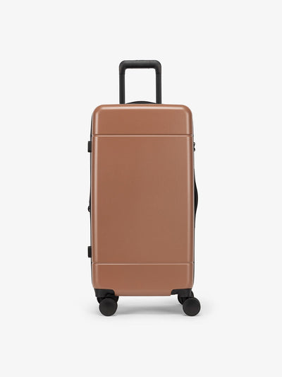 CALPAK Hue Medium Trunk Luggage with durable hard-shell exterior, cushioned top handle and 360 spinner wheels in hazel; LHU1026-HAZEL
