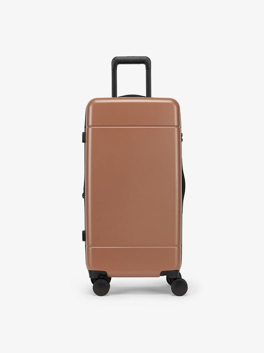 CALPAK Hue Medium Trunk Luggage with durable hard-shell exterior, cushioned top handle and 360 spinner wheels in hazel; LHU1026-HAZEL