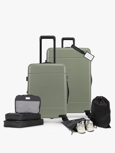 CALPAK Hue Starter Bundle in green Juniper that comes with Large and Carry On Luggage, Luggage Tag, Two Black Pouches, and Three Black Packing Cubes shown on a white background; LHU8000-JUNIPER