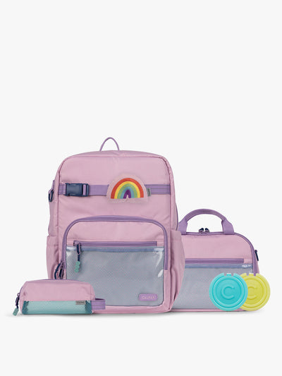 CALPAK Kids Collection Large Kids Backpack Bundle in pink lavender Orchid Pink that includes Kids Lunch Bag, Kids Pencil Case, Rainbow Pluffy Bag Charm, and Set of 2 Ice Packs in a kid's room; BCKL5000-ORCHID-PINK