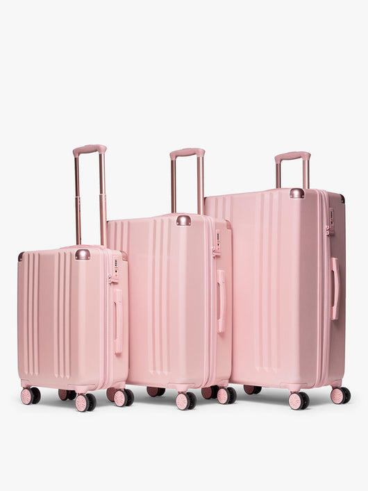 CALPAK pc Ambeur Luggage Set featuring the Ambeur Carry-On Luggage, Ambeur Medium Luggage and Ambeur Large Luggage in metallic pink Blossom with pink wheels;  LAM3000-BLOSSOM