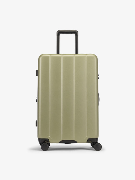 CALPAK Green pistachio medium luggage made from an ultra-durable polycarbonate shell and expandable by up to 2"; LCO1024-PISTACHIO