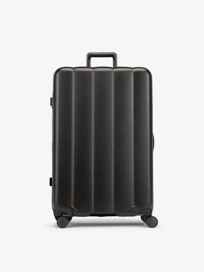 Black CALPAK large luggage made from an ultra-durable polycarbonate shell and expandable by up to 2"; LCO1028-BLACK