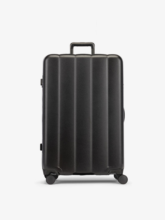Black CALPAK large luggage made from an ultra-durable polycarbonate shell and expandable by up to 2"; LCO1028-BLACK
