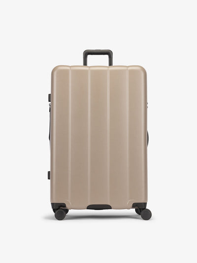 CALPAK Brown chocolate large luggage made from an ultra-durable polycarbonate shell and expandable by up to 2"; LCO1028-CHOCOLATE