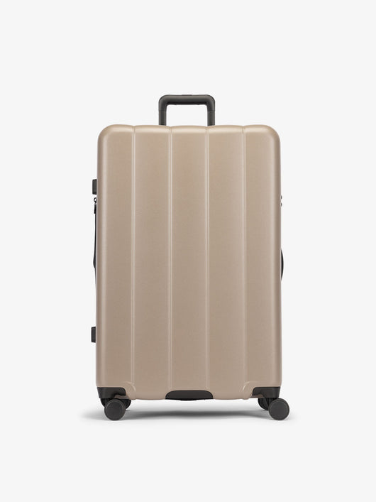 CALPAK Brown chocolate large luggage made from an ultra-durable polycarbonate shell and expandable by up to 2"; LCO1028-CHOCOLATE