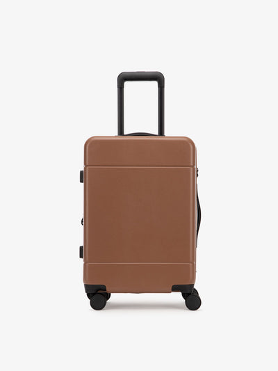 CALPAK Hue hard shell rolling carry-on luggage in pink sand color; LHU1020-NP-HAZEL