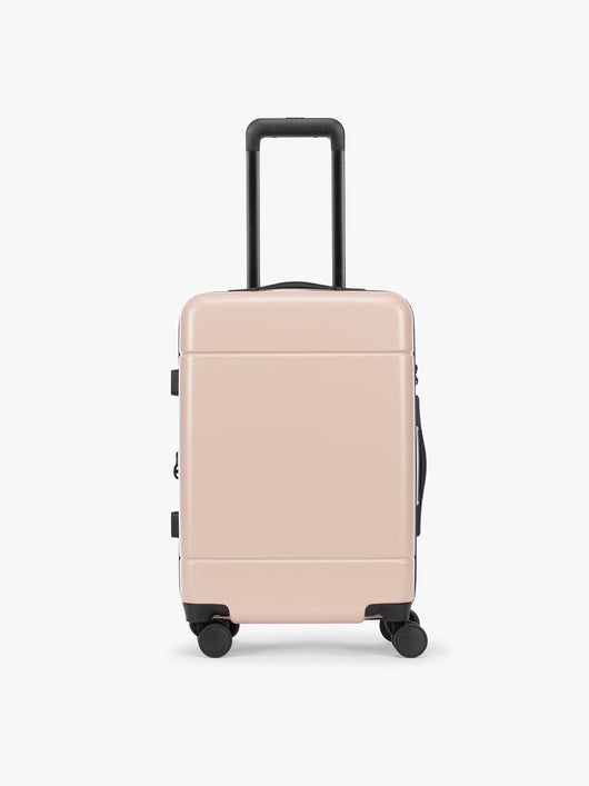 CALPAK Hue Carry On Luggage in light pink Rose Quartz with handle and wheels on a white background; LHU1020-NP-ROSE-QUARTZ