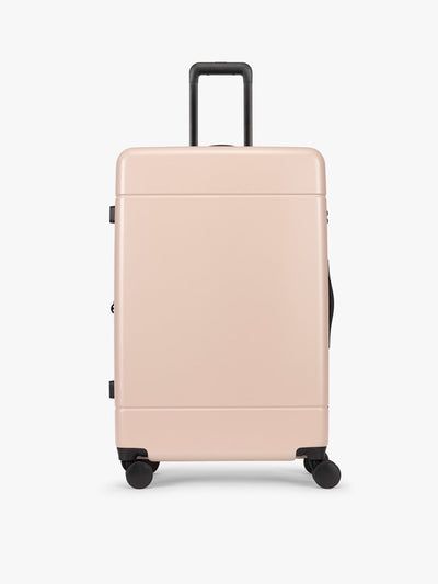 CALPAK Hue Large Luggage in light pink Rose Quartz with handle and wheels on a white background; LHU1028-ROSE-QUARTZ