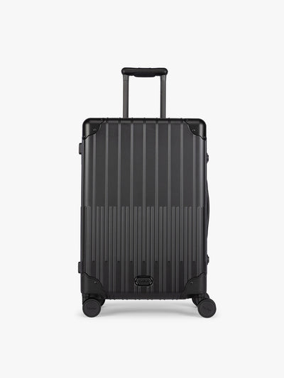 CALPAK Vault Luggage Onyx black hard-shell spinner suitcase with a ribbed vertical design, shown from the front against a clean white background; LVT1024-ONYX