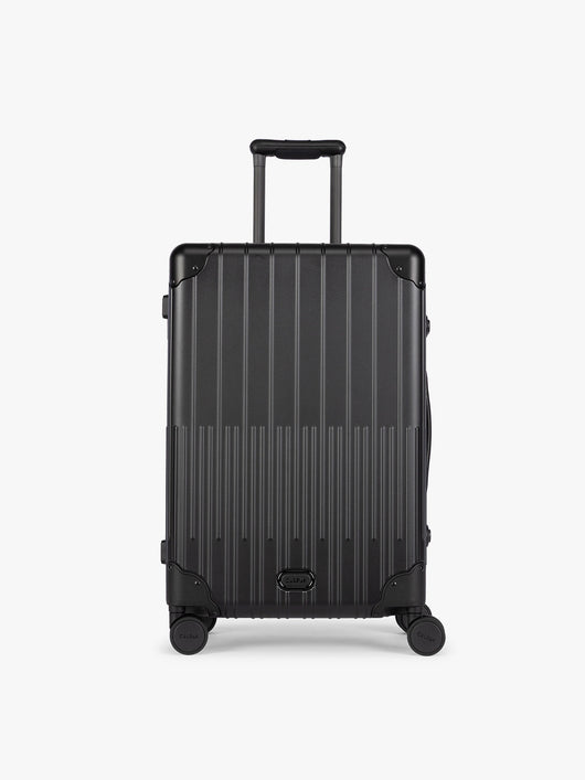 CALPAK Vault Luggage Onyx black hard-shell spinner suitcase with a ribbed vertical design, shown from the front against a clean white background; LVT1024-ONYX