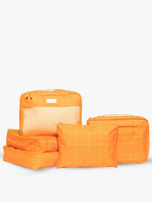 CALPAK 5 piece set packing cubes for travel with labels and top handles in orange grid; PC1601-ORANGE-GRID
