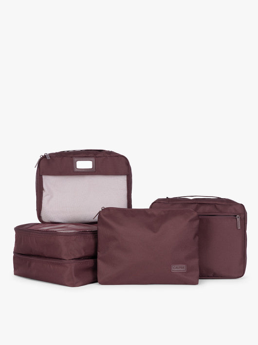 Burgundy Dark Cherry CALPAK 5-piece travel packing cubes set which includes three mesh cubes, a flat cube, and a zippered organizer, displayed on a clean white background; PC1601-DARK-CHERRY