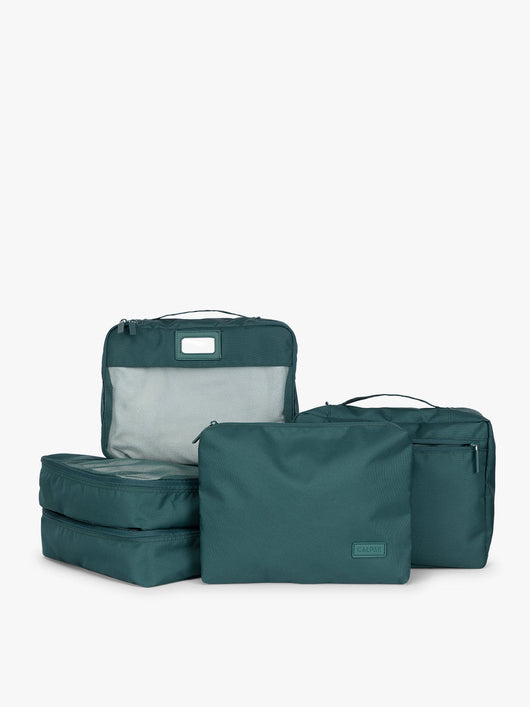 Deep green teal Kale CALPAK 5-piece travel packing cubes set which includes three mesh cubes, a flat cube, and a zippered organizer, displayed on a clean white background;PC1601-KALE