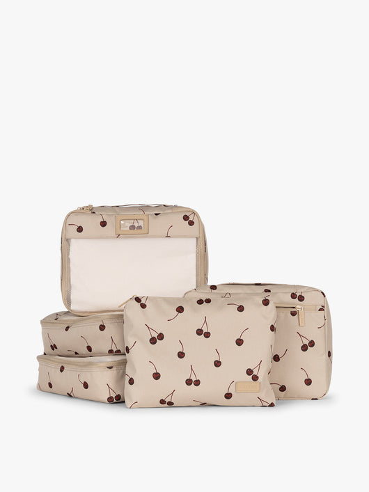 CALPAK Packing Cubes 5pc Set in beige with cherry print in Oatmeal Cherry on a white background; PC1601-OATMEAL-CHERRY
