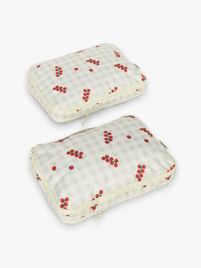 CALPAK Medium Compression Packing Cubes in white and green gingham pattern with tomato print; PCC2201-CELADON-TOMATO-PICNIC