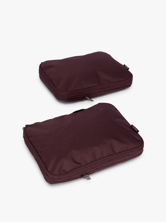 Two burgundy Dark Cherry CALPAK Medium Compression Packing Cubes with zippers shown on a clean white background; PCC2201-DARK-CHERRY