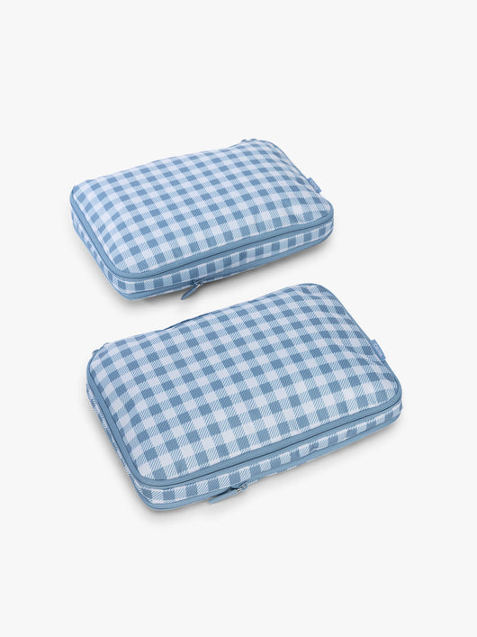 CALPAK Medium Compression Packing Cubes (Set of 2) compressed in white and blue gingham print in French Blue Gingham; PCC2201-FRENCH-BLUE-GINGHAM