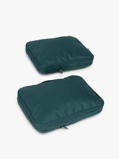 Two dark green teal Kale CALPAK Medium Compression Packing Cubes with zippers shown on a clean white background; PCC2201-KALE